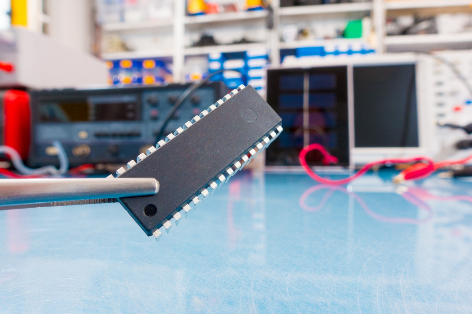 A quantum computer's chip, being held in the air in a laboratory setting.