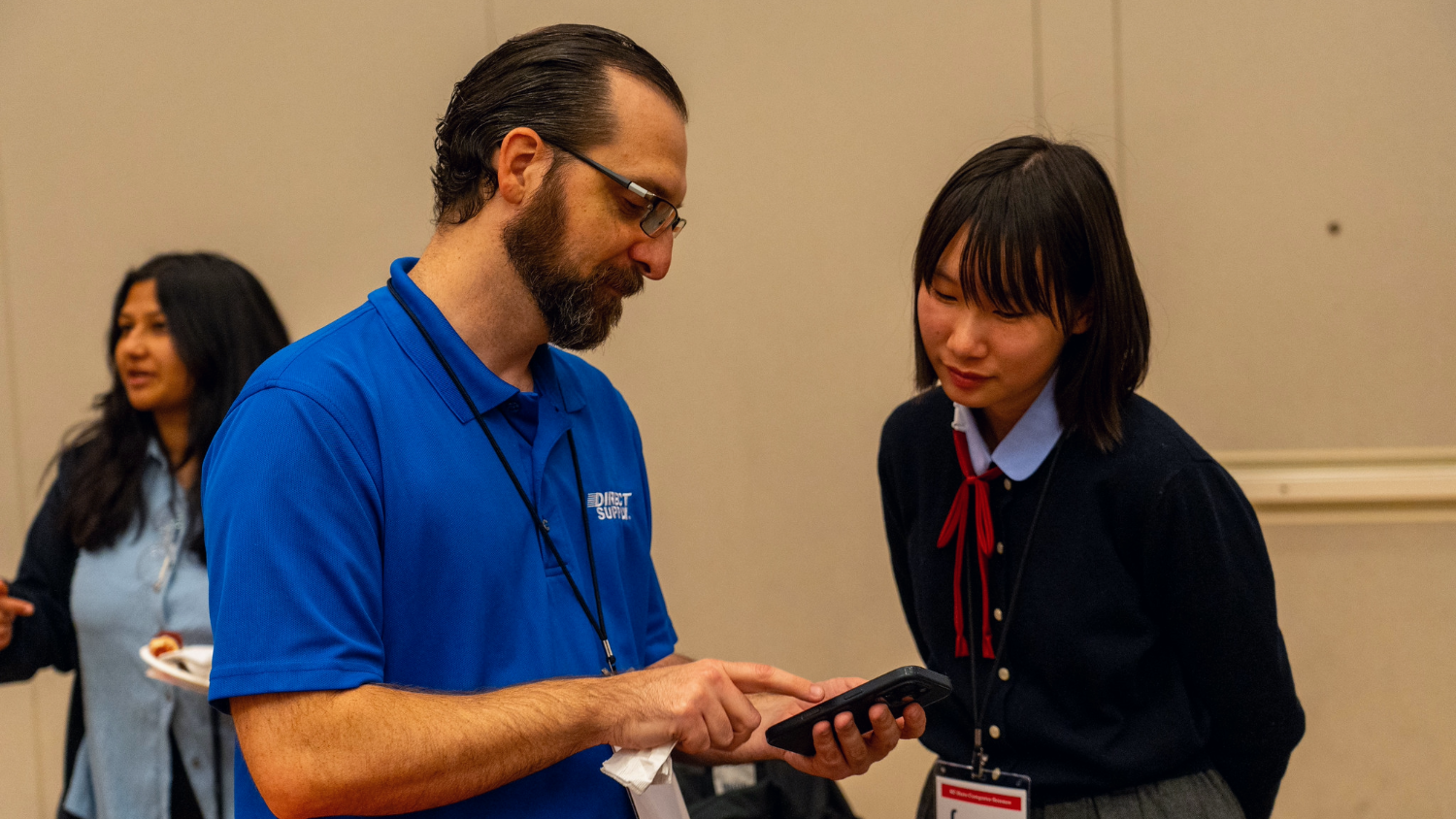 Two people looking at a cell phone