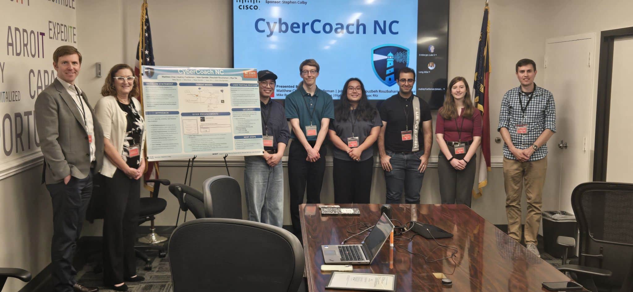 A group of people standing in front of a presentation on cybersecurity
